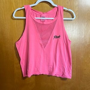 Cropped tank top with fish net cutout in the front.